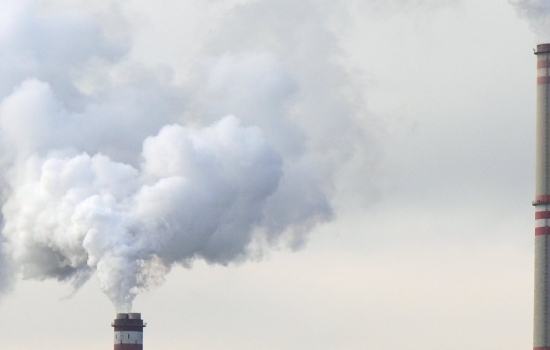 Two chimneys releasing smoke into the sky Two chimneys releasing smoke into the sky