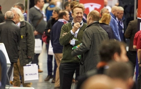 People standing chatting at an expo People standing chatting at an expo