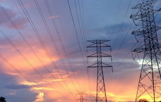 Electricity pylons with a sunset in the background Electricity pylons with a sunset in the background