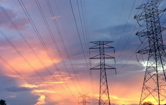 Electricity pylons with a sunset in the background