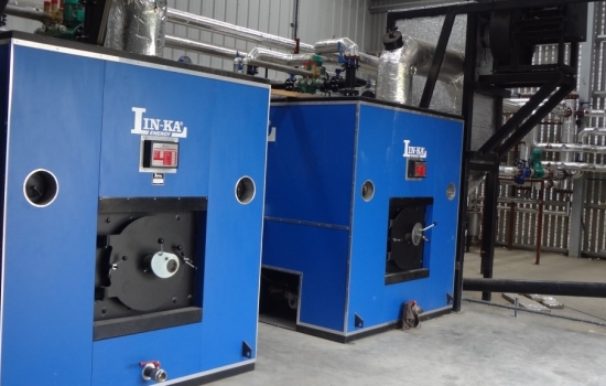 two blue biomass boilers in a shed two blue biomass boilers in a shed