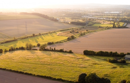 Rolling countryside fields with grass and crops Rolling countryside fields with grass and crops