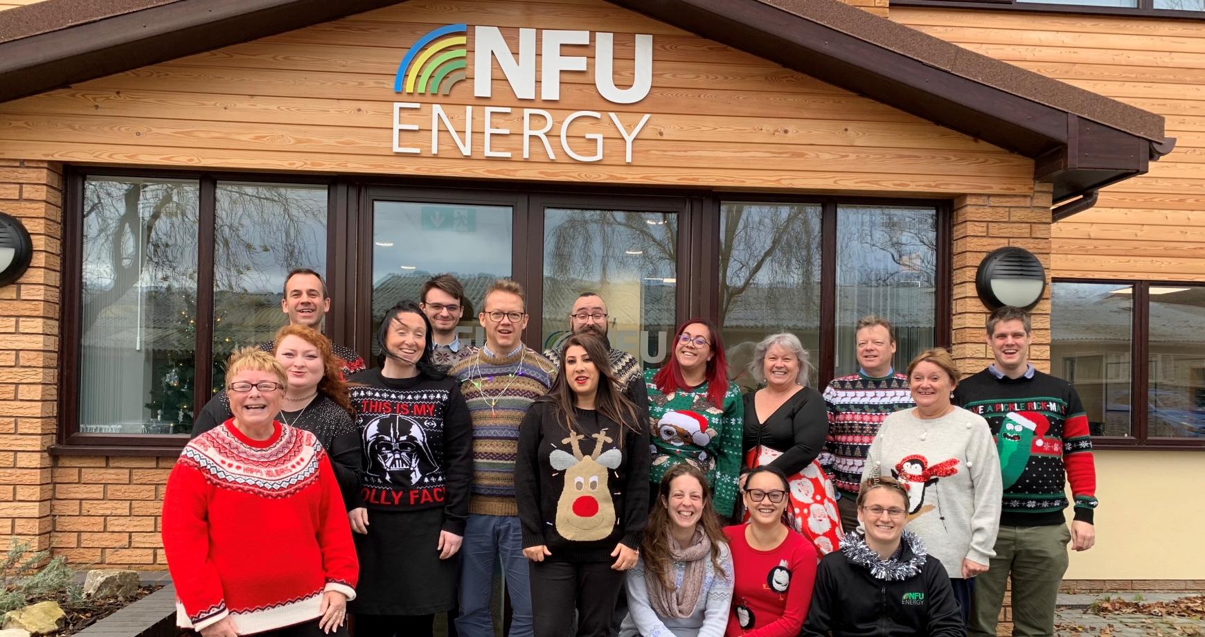 Staff in Christmas Jumpers outside the front of the office