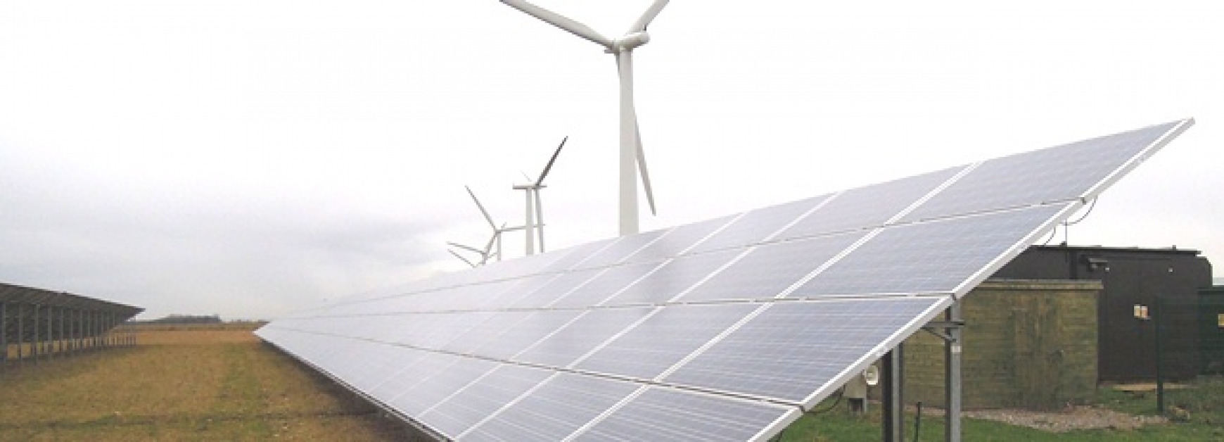 Solar panels with wind turbines behind